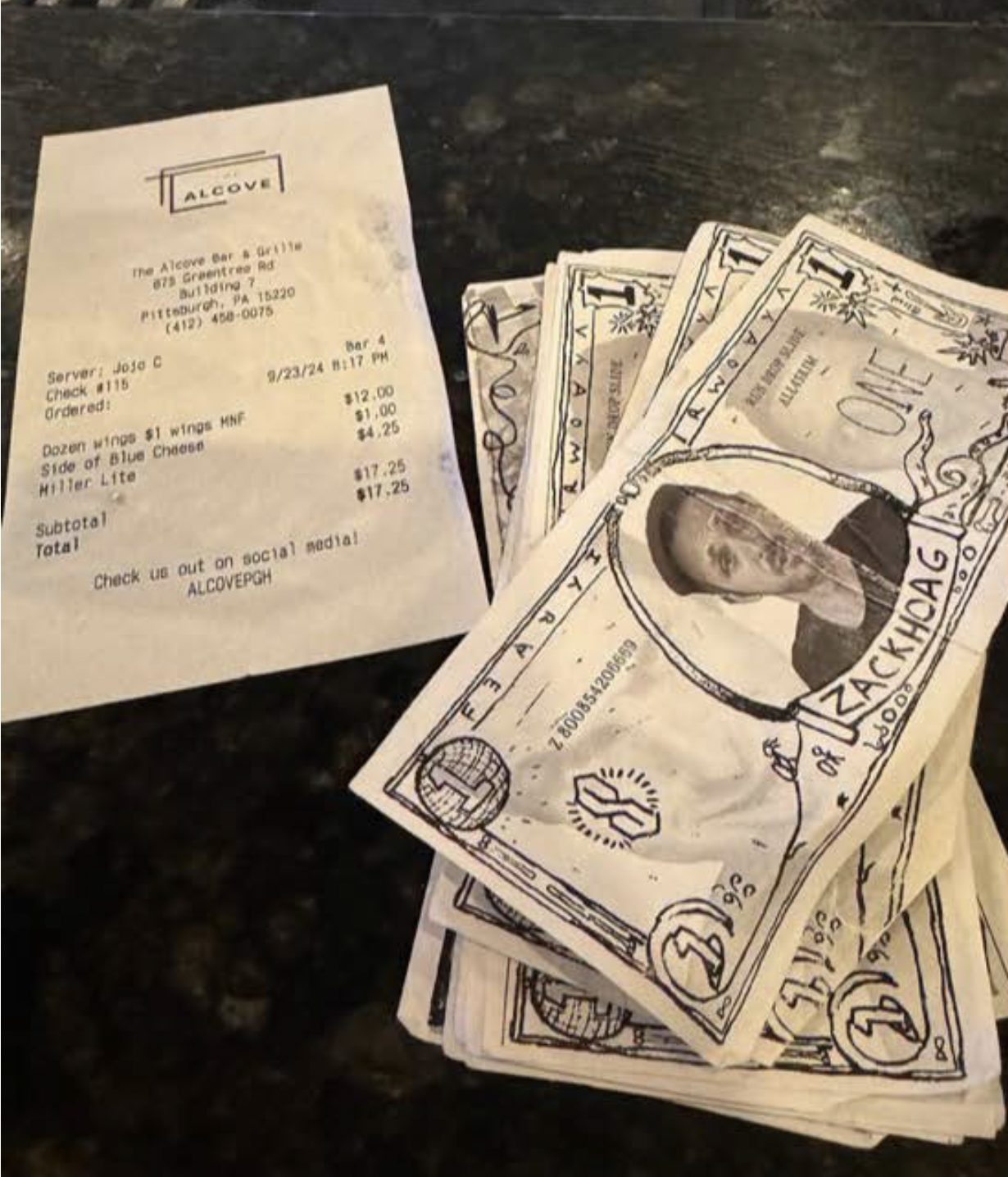 Zack Back notes left as a tip beside a genuine printed receipt on a bar counter.