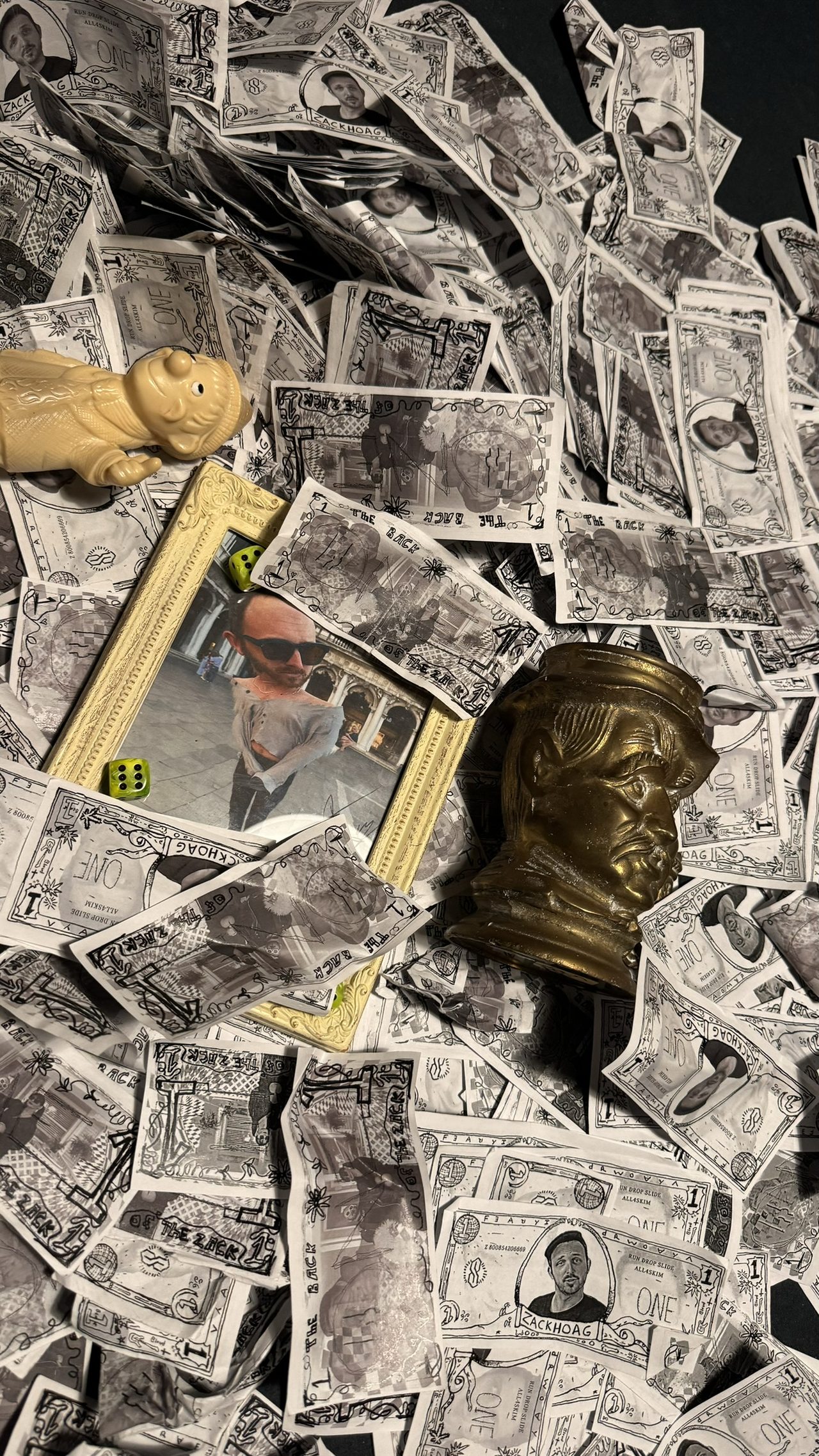 A man gazes intently at a thick fan of paper notes held close to his face.