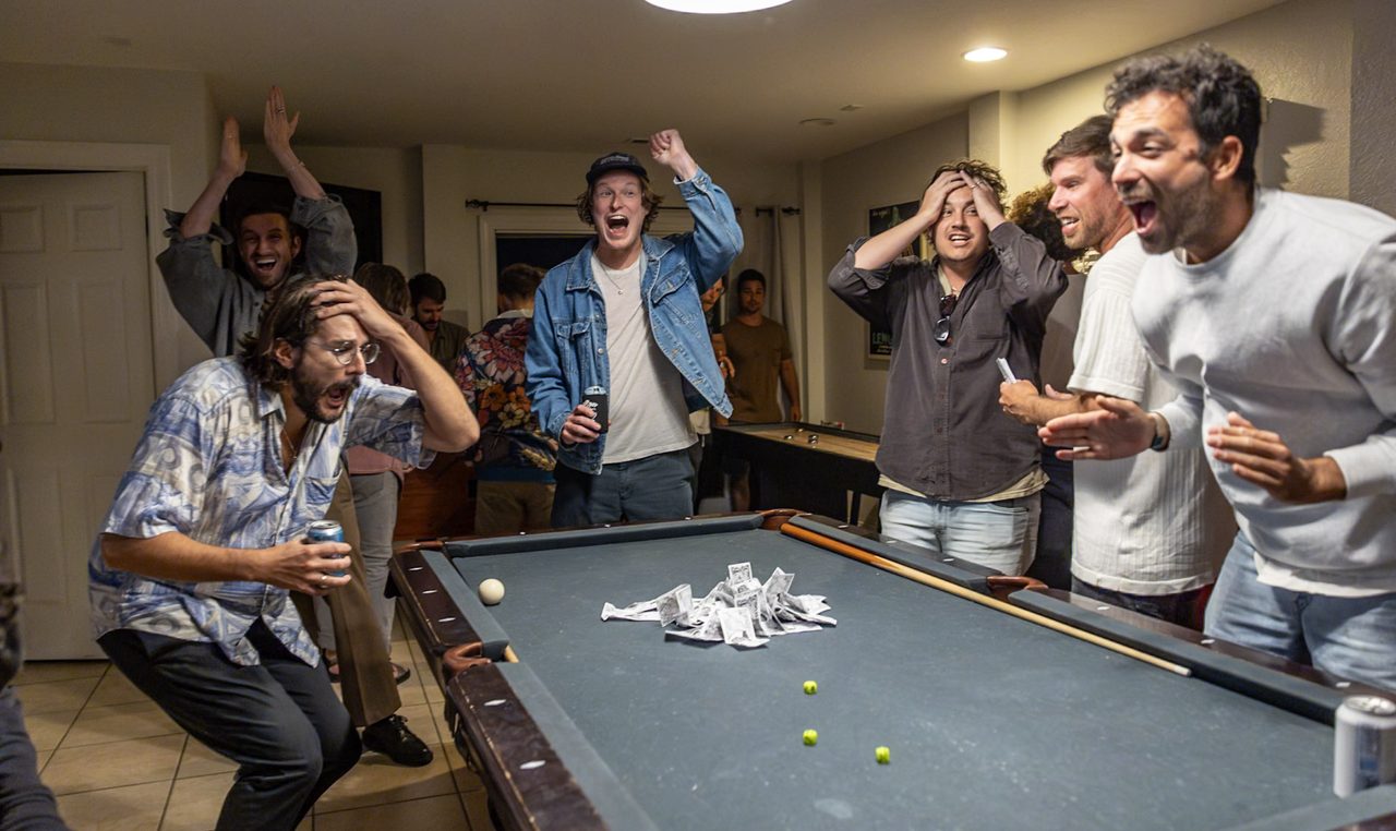 The room erupts around the table as the final dice roll lands.