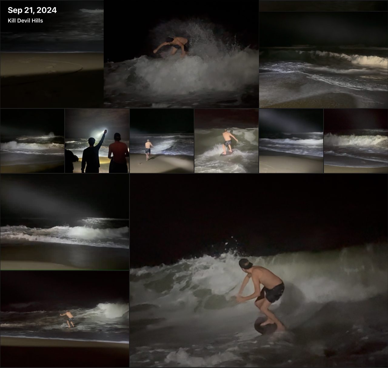 A night photograph of a man skimboarding through dark surf, lit by a handheld light.